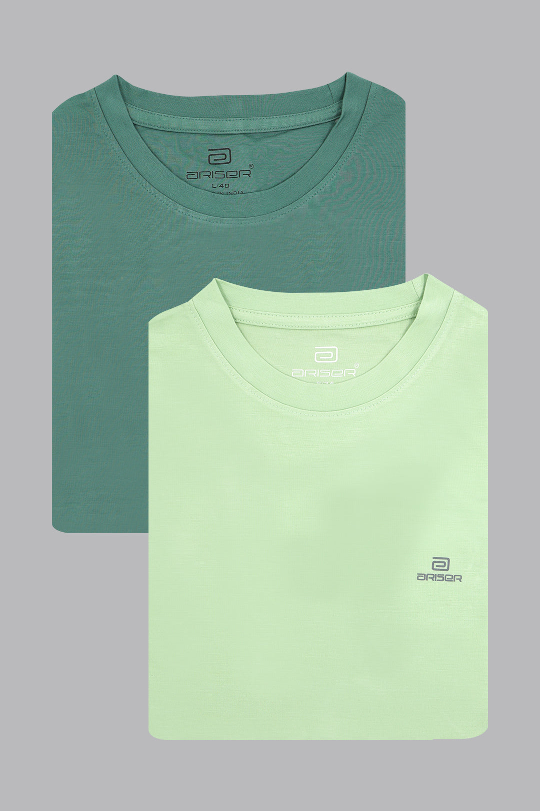 Two folded t-shirts, one green and one light green, on a gray background.