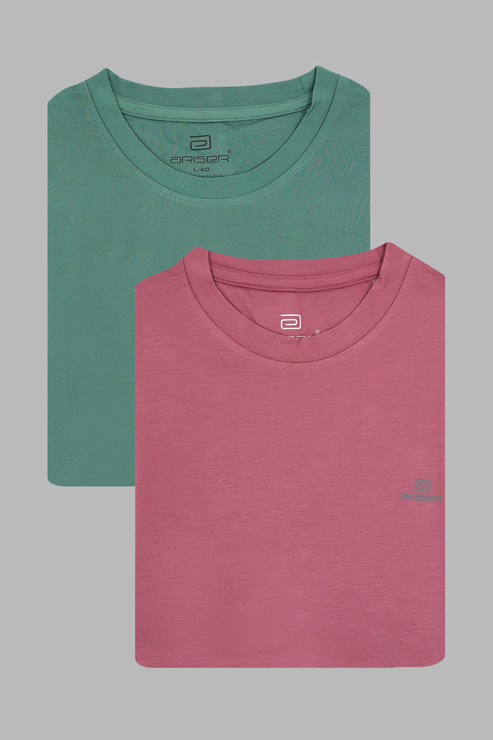 Two folded t-shirts, one green and one pink, on a gray background.