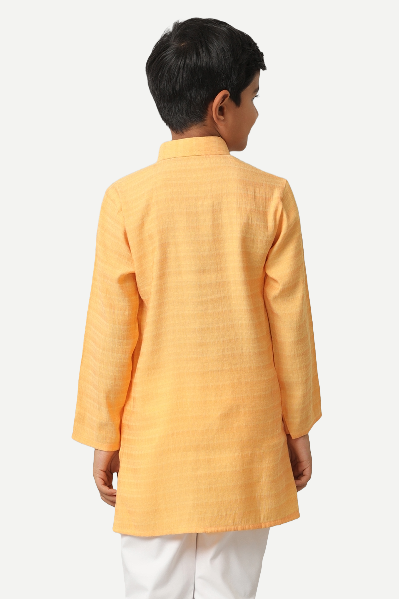 A boy in Yellow Kurta Shirt and White Pants
