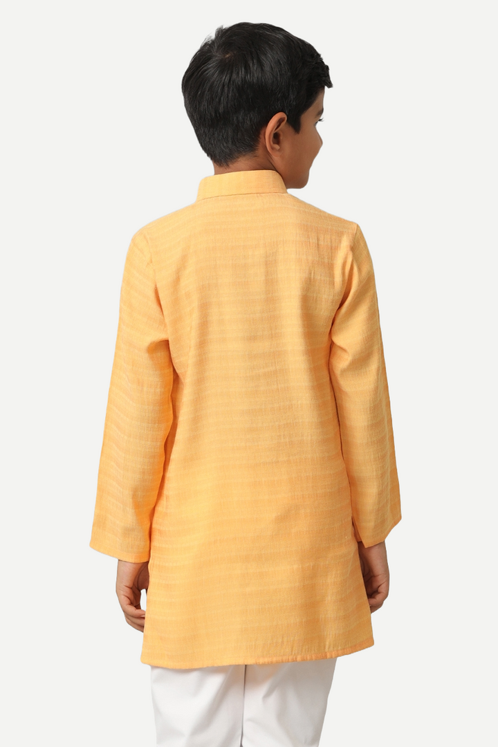 A boy in Yellow Kurta Shirt and White Pants