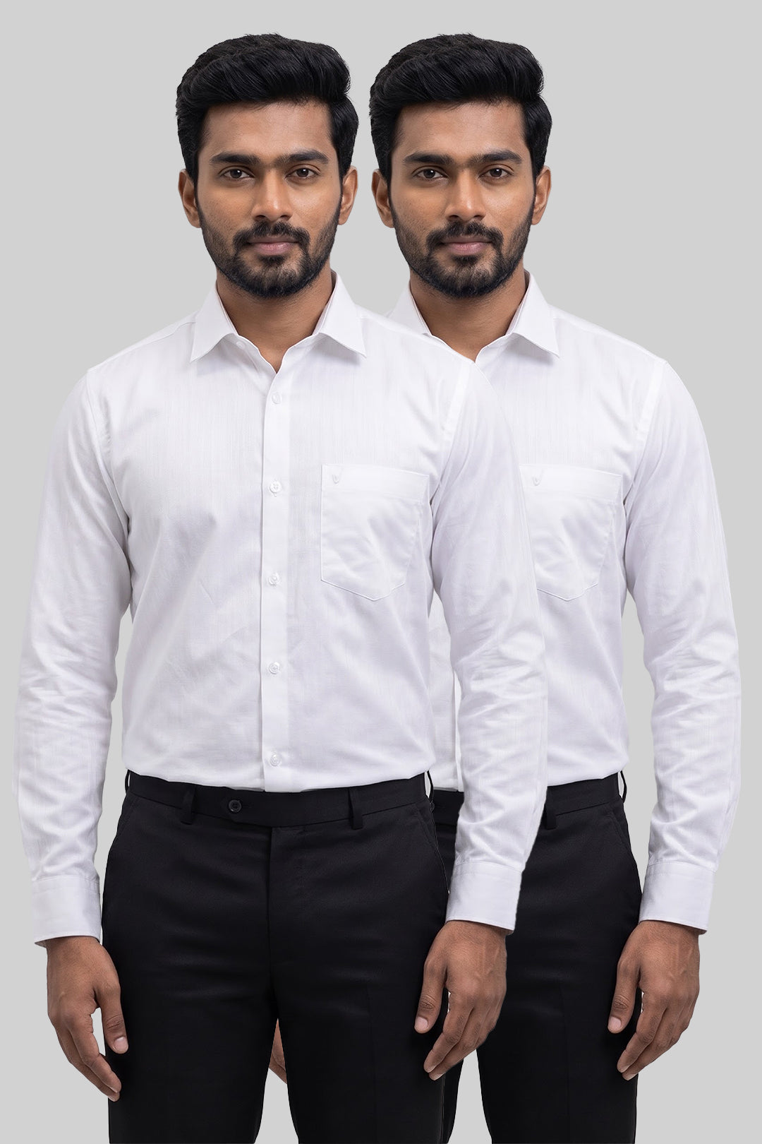 Two men modeling matching white long-sleeve dress shirts and black trousers against a plain light gray studio background.