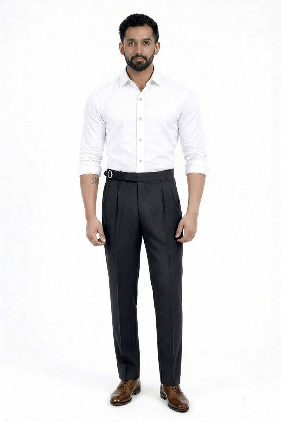 Man wearing a white shirt and dark trousers on a white background