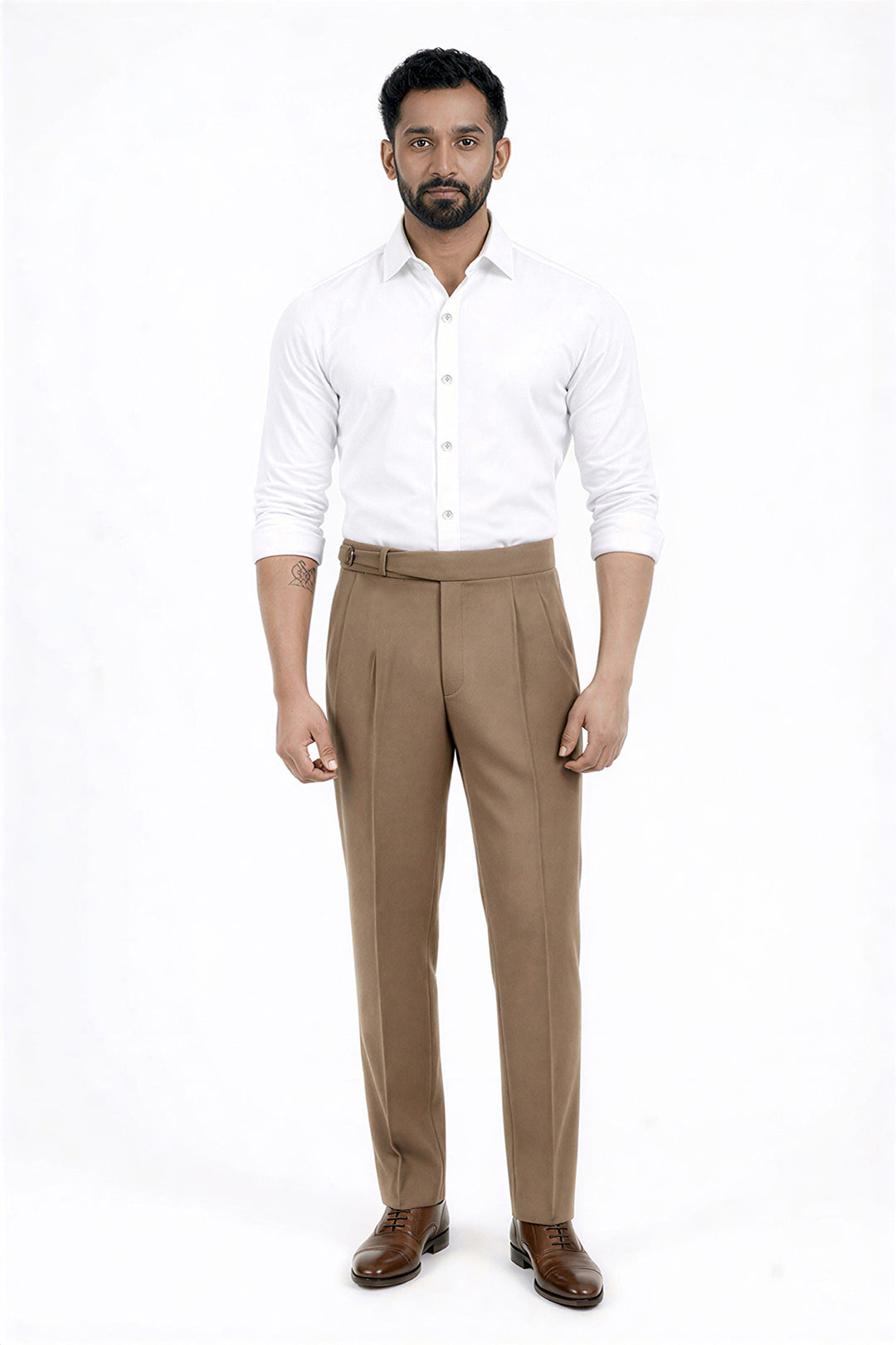 Man wearing a white shirt and beige pants on a white background
