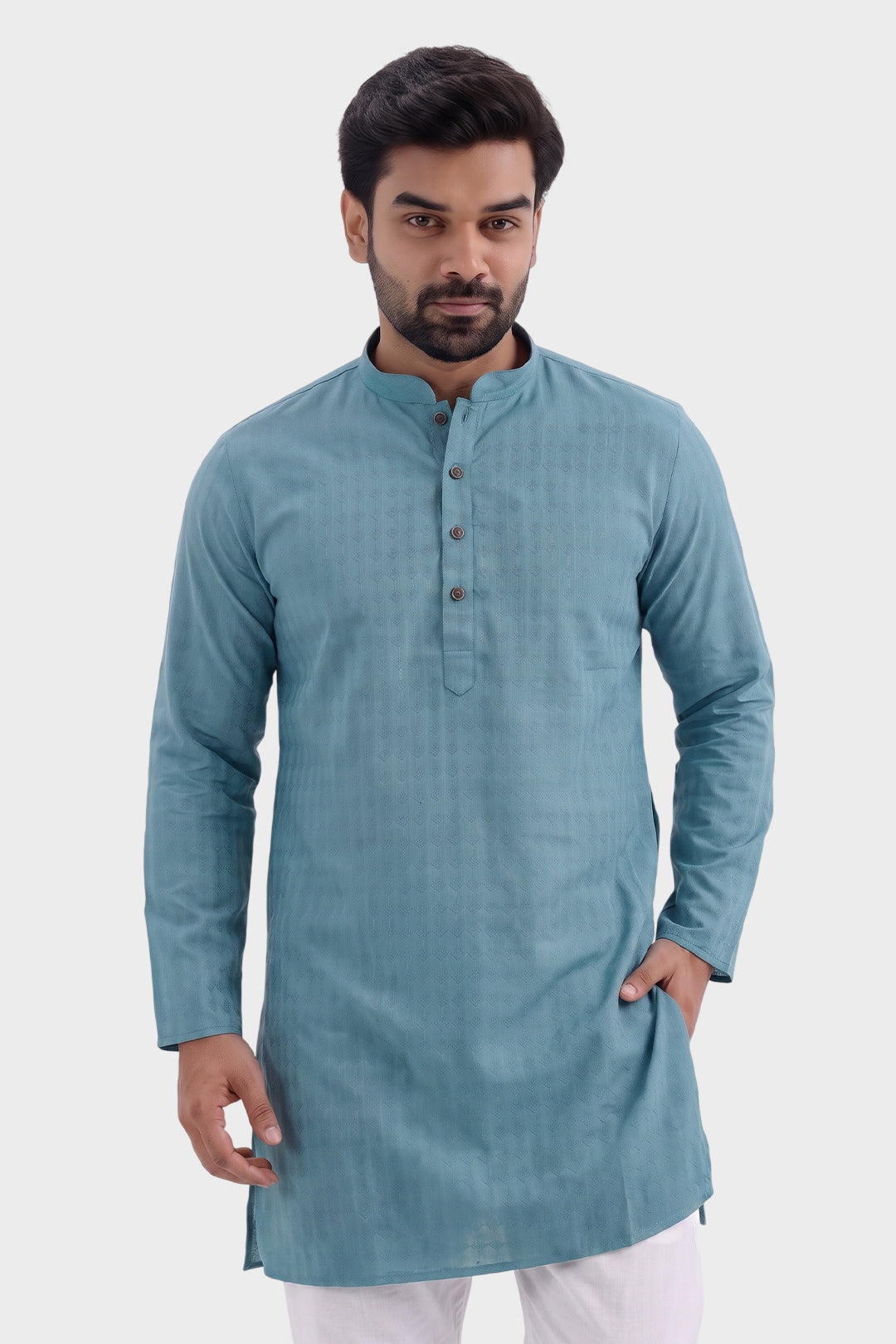 A man wearing a light blue-green long-sleeve kurta with a mandarin collar and three-button placket, paired with white trousers, set against a plain light gray background.