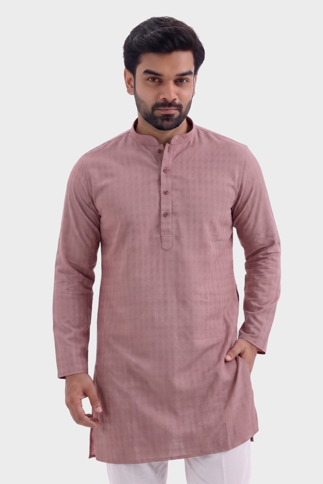 A man wearing a dusty rose pink long-sleeve kurta with a mandarin collar and button placket, paired with white trousers, photographed against a light gray studio background.