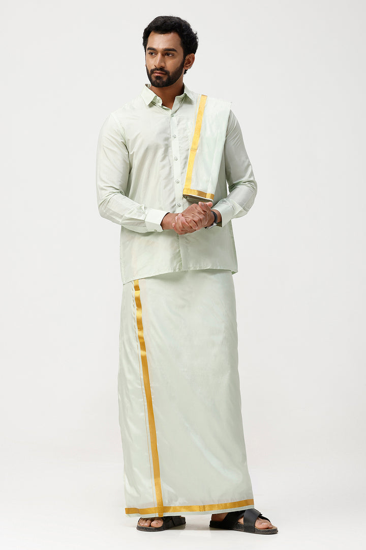 Man wearing a traditional white outfit with gold accents on a white background