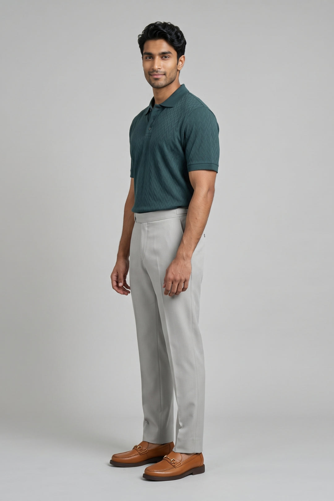 Green T-shirt with versatile grey pants.