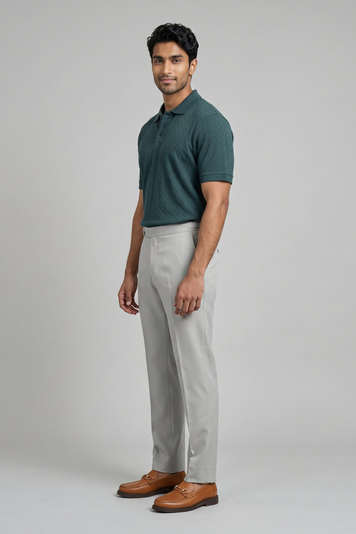 Green T-shirt with versatile grey pants.