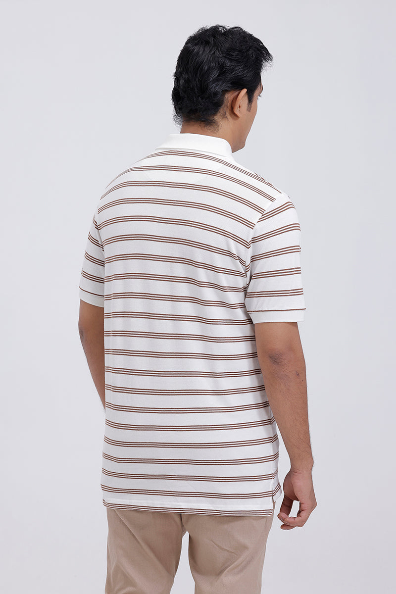 Man wearing a striped polo shirt and beige pants on a white background