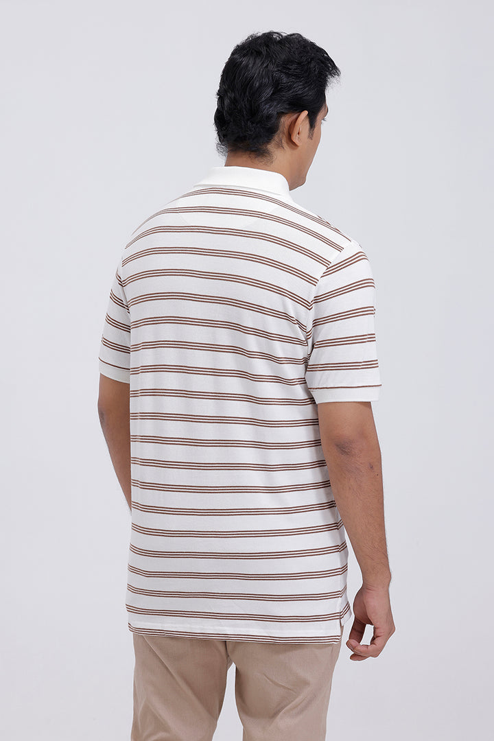 Man wearing a striped polo shirt and beige pants on a white background