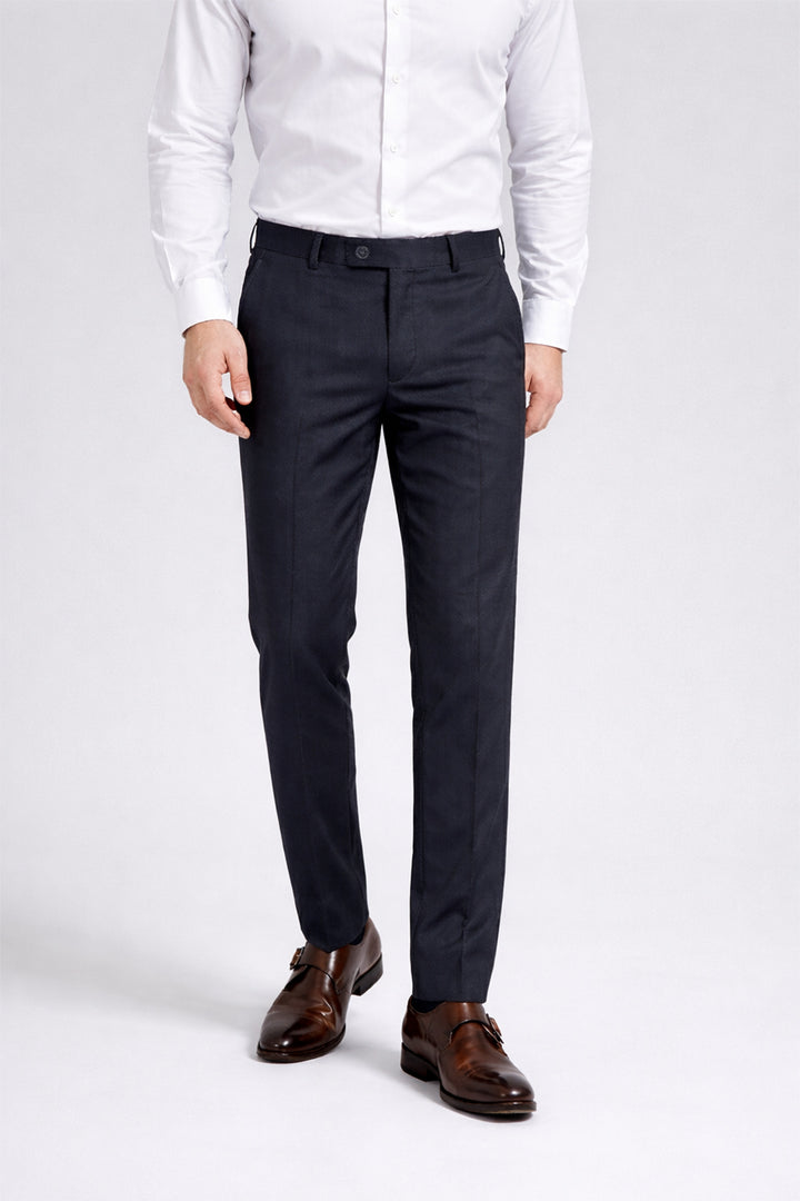 Person wearing a white dress shirt, dark navy pant, and brown shoes on a white background