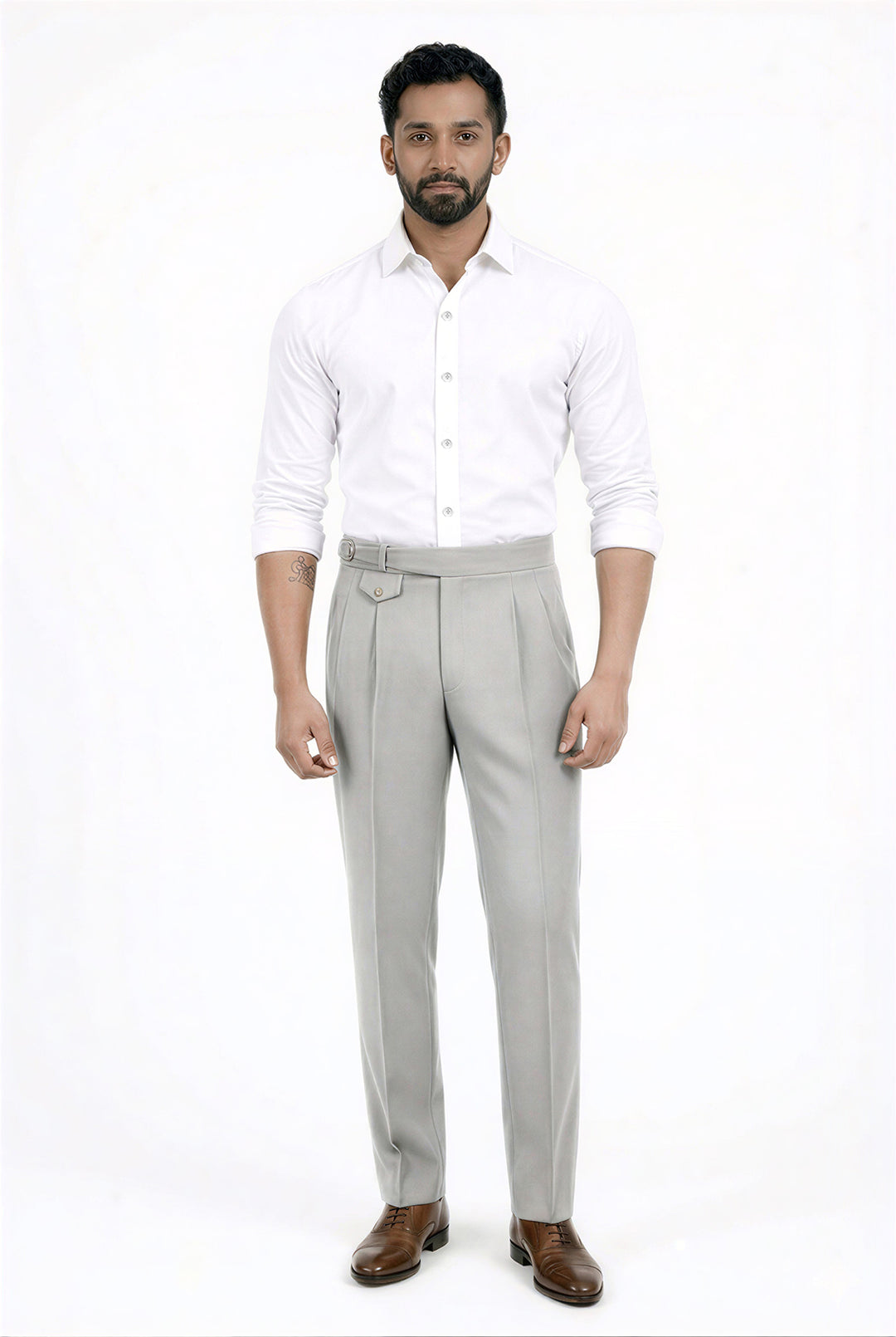 Man wearing a white shirt and gray pants on a white background