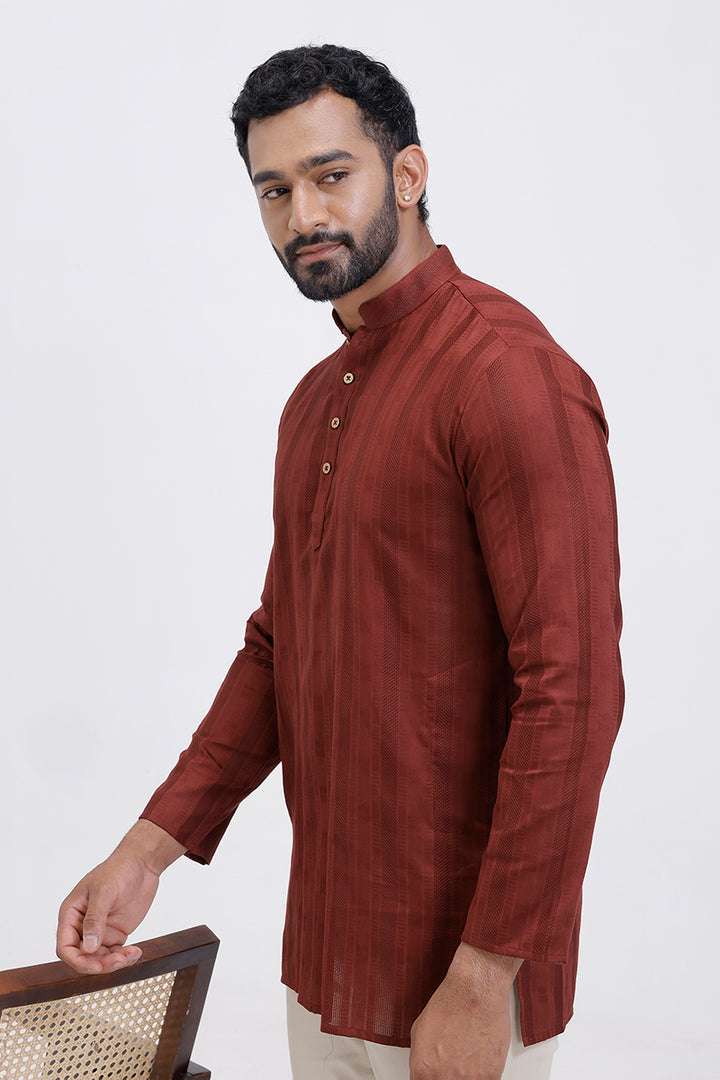 Man wearing a red kurta with a white background