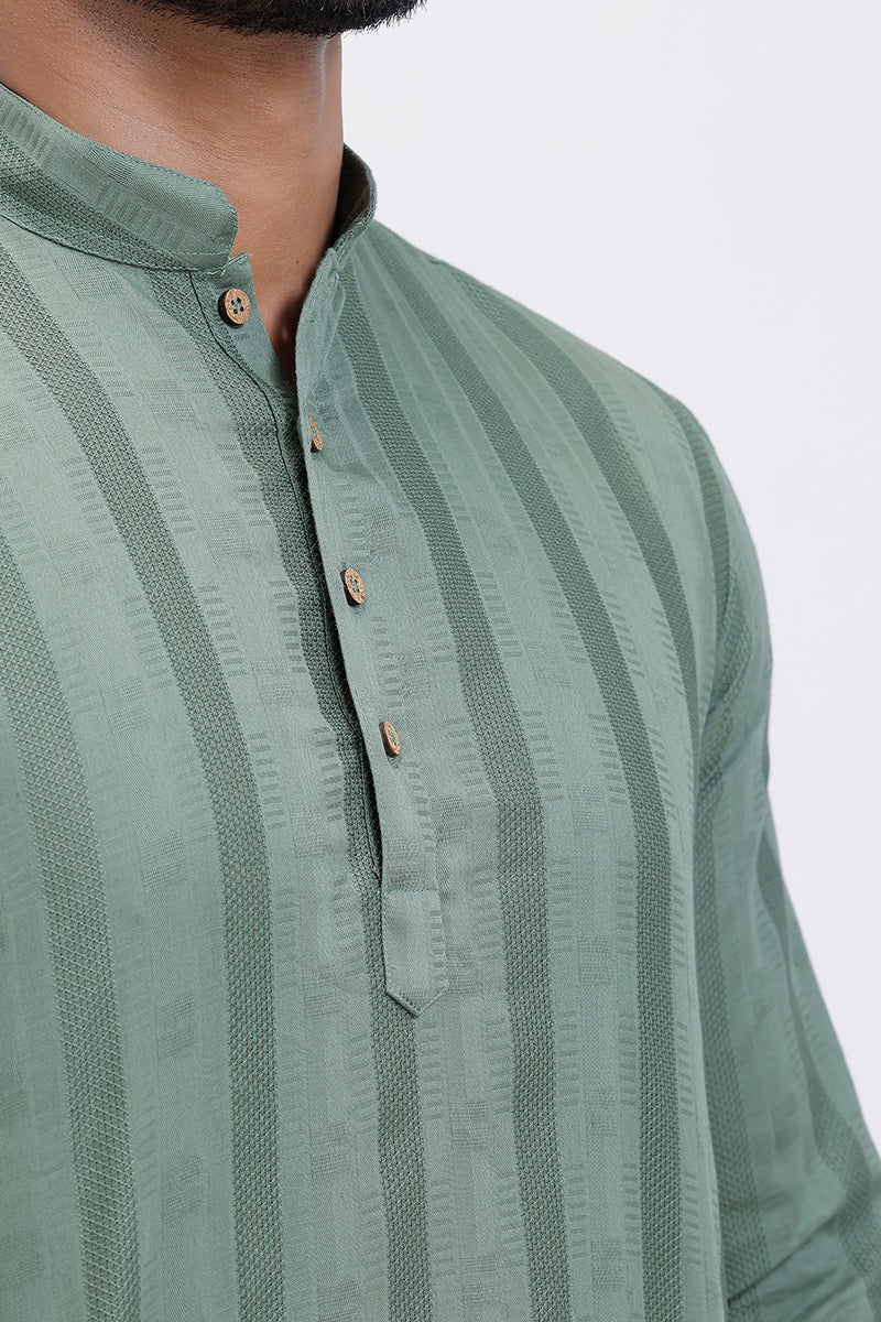 Green striped shirt worn by a person on a white background