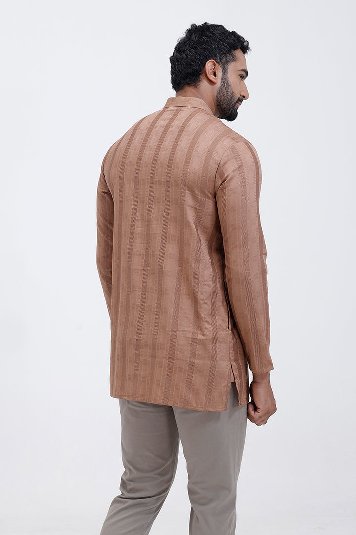 Man wearing a brown striped kurta and beige pants on a white background