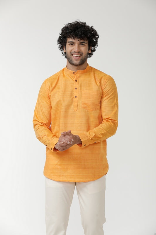 Man wearing an orange short kurta 
