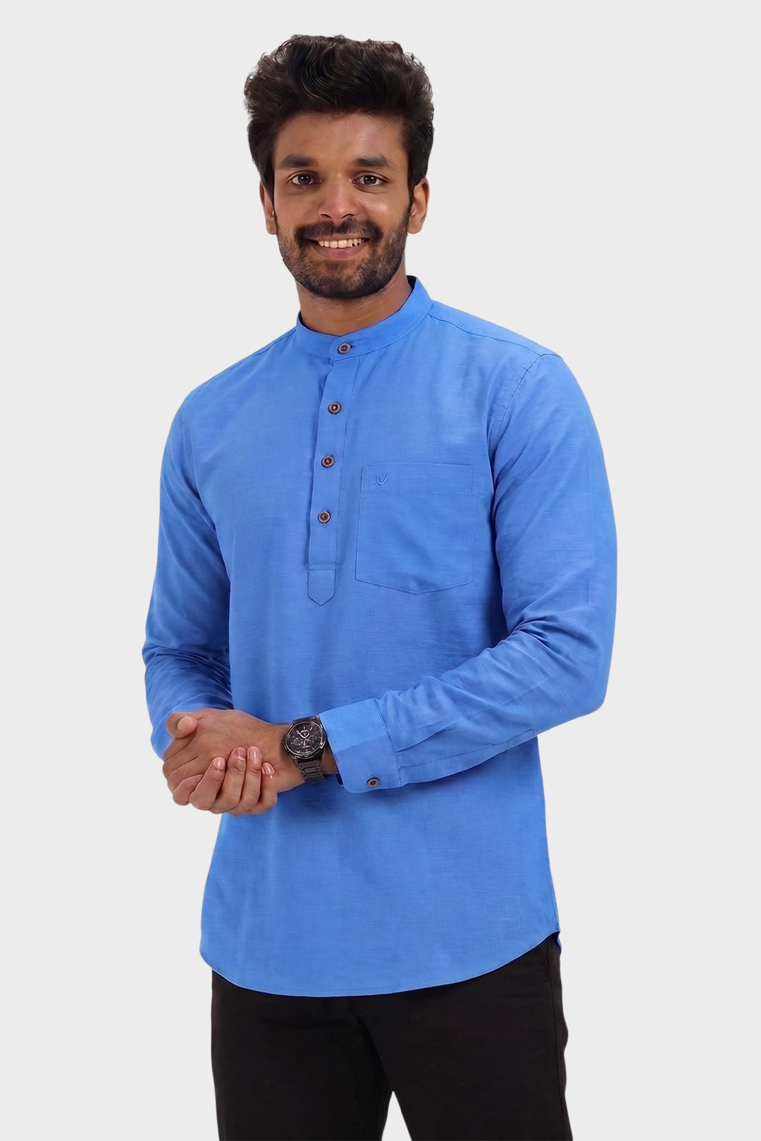 A man wearing a bright blue long-sleeve kurta with a mandarin collar and three-quarter button placket, paired with black trousers, set against a plain light gray background.