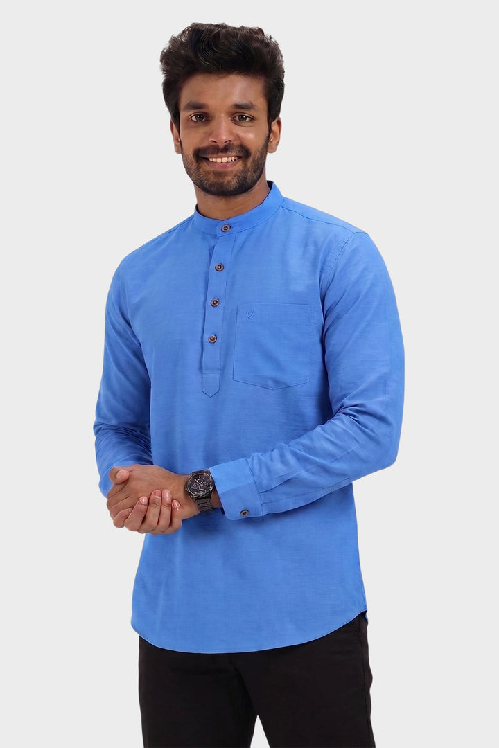 A man wearing a bright blue long-sleeve kurta with a mandarin collar and three-quarter button placket, paired with black trousers, set against a plain light gray background.