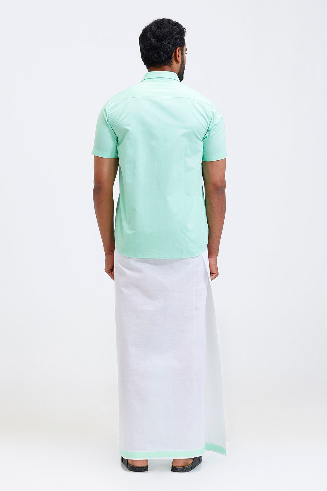 South Indian traditional wear bright green shirt and fancy border dhoti