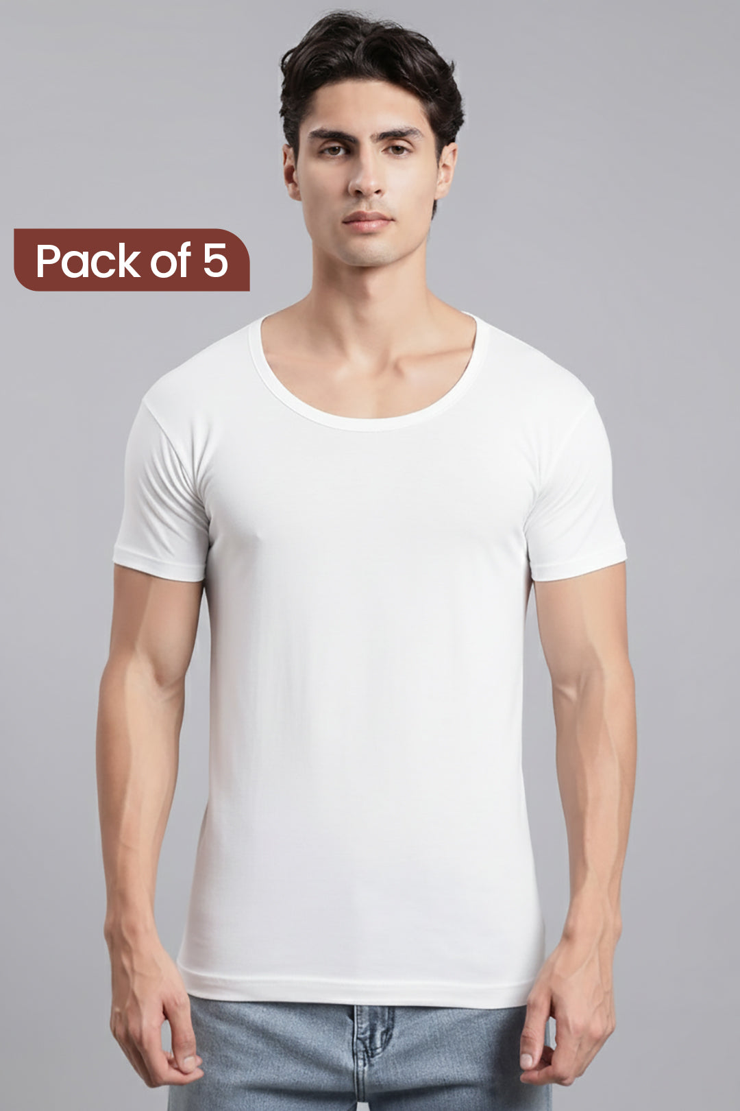 A man wearing a plain white vest, sleeve-crew-neck T-shirt, paired with light blue jeans, against a solid gray studio background. A brown label in the top-left corner reads 'Pack of 5'.