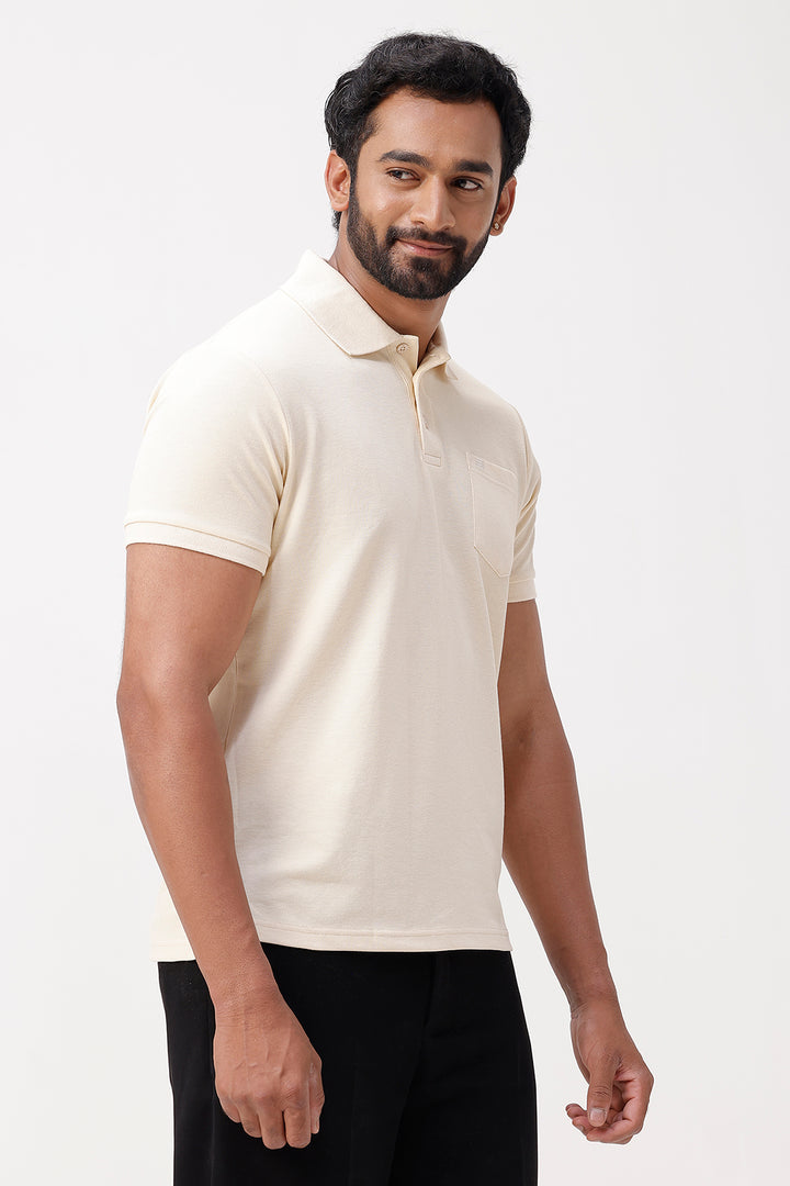 Man wearing a beige polo shirt against a white background