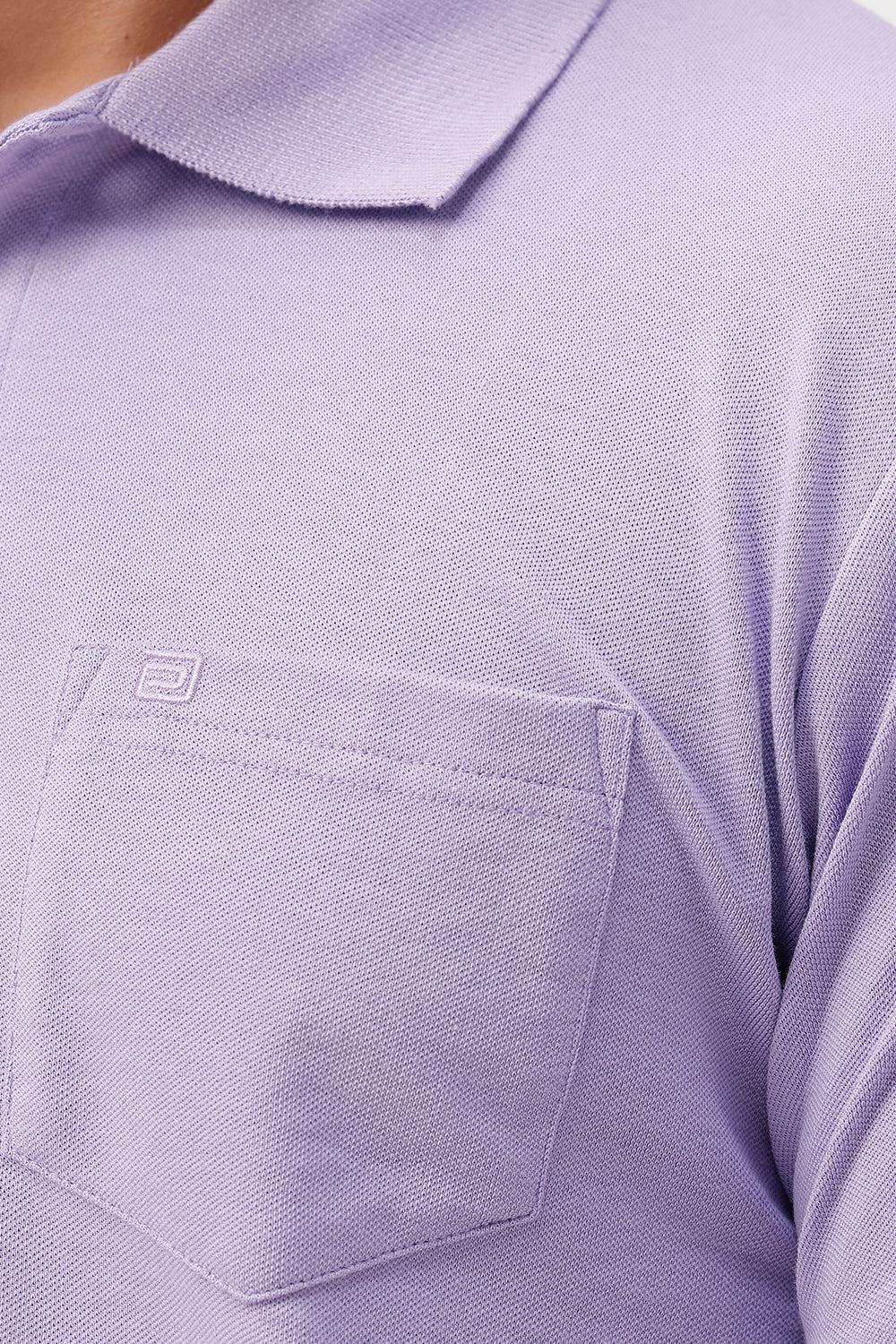 Close-up of a soft lavender polo shirt with a pocket and brand logo.
