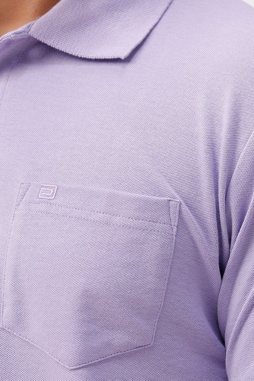 Close-up of a soft lavender polo shirt with a pocket and brand logo.