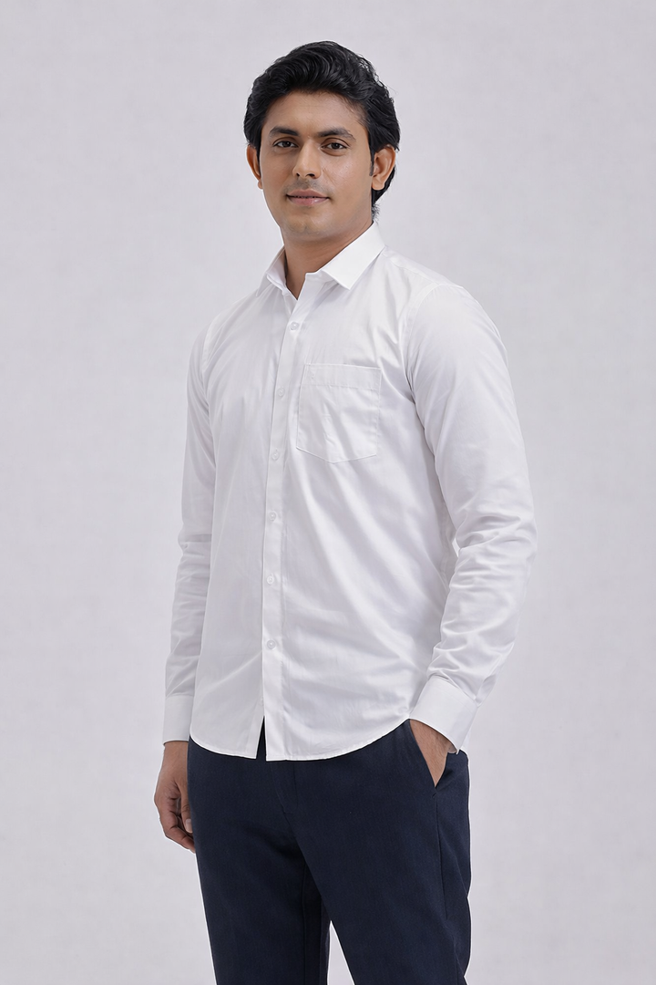 Man wearing a white dress shirt and dark pants on a light gray background